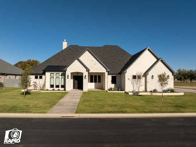 french provincial home with a front yard