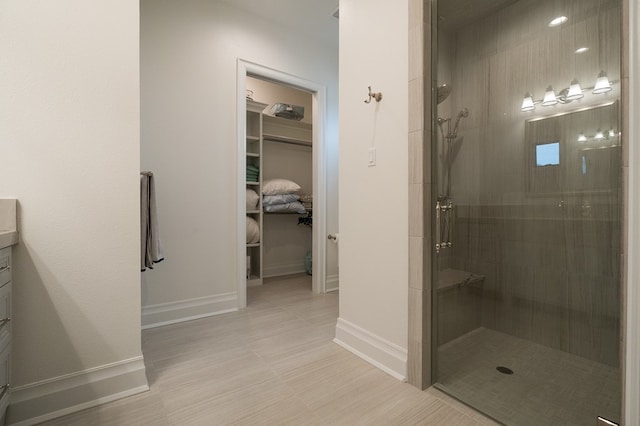 bathroom featuring vanity and a tile shower