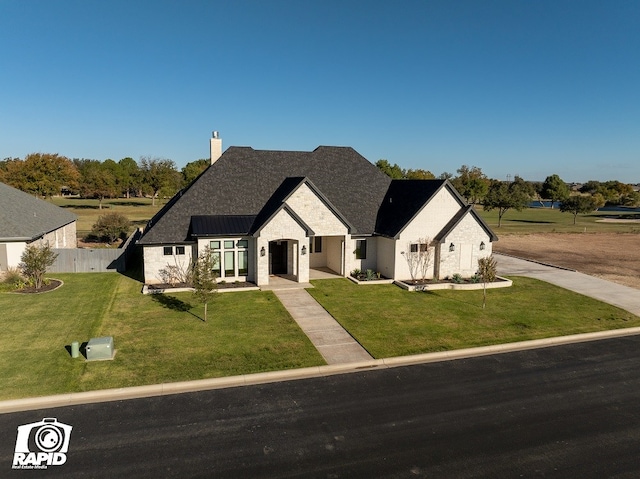 french provincial home with a front lawn