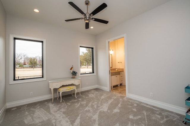 office featuring light carpet and ceiling fan