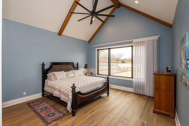 bedroom with beamed ceiling, ceiling fan, high vaulted ceiling, and light hardwood / wood-style flooring