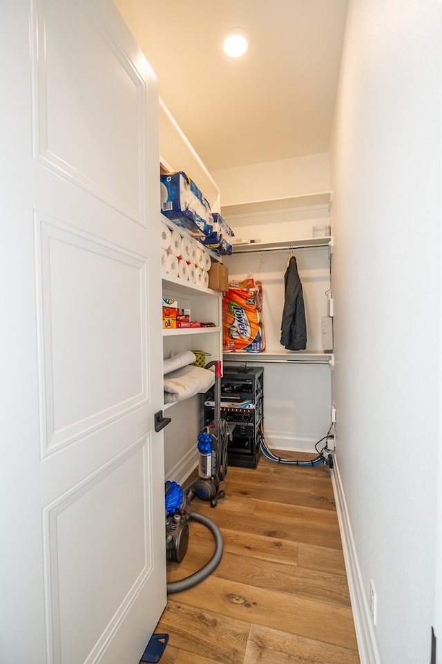 spacious closet featuring light hardwood / wood-style floors