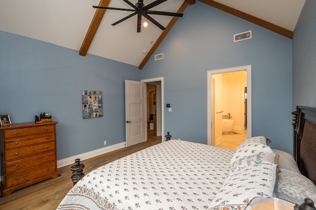 bedroom featuring hardwood / wood-style floors, high vaulted ceiling, beamed ceiling, ceiling fan, and ensuite bath