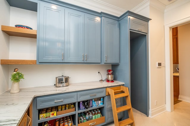 kitchen featuring crown molding, light stone countertops, and blue cabinetry