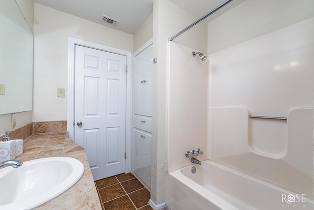 1726 S Park St, San Angelo, TX 76901 - bathroom with shower / bathtub combination, visible vents, tile patterned flooring, and vanity