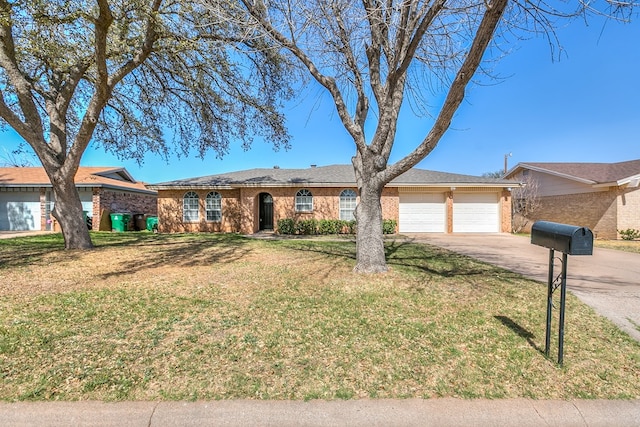 ranch-style home featuring a garage, brick siding, concrete driveway, and a front yard