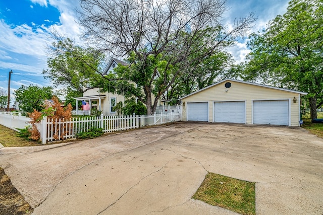 view of front facade featuring a garage and an outdoor structure