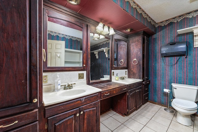 bathroom with vanity, tile patterned floors, a textured ceiling, and toilet