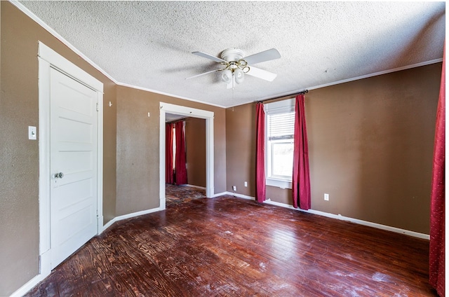 spare room featuring a textured ceiling, dark wood-type flooring, ornamental molding, and ceiling fan