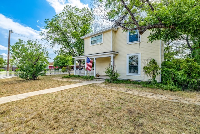 view of front of property featuring covered porch and a front lawn