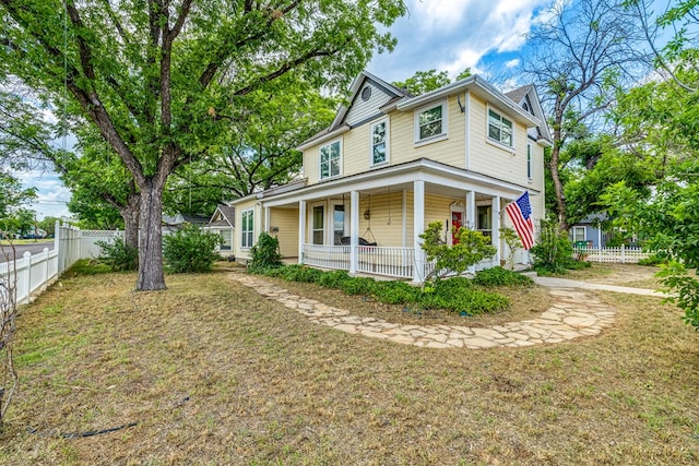 view of front of property with a porch and a front yard