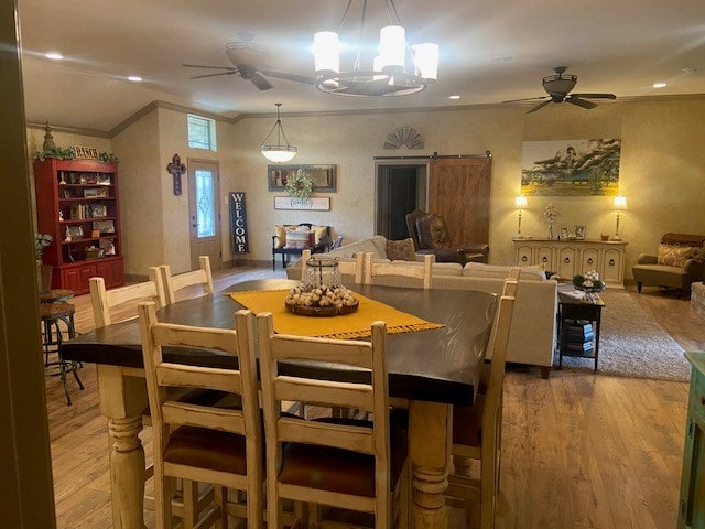 11725 Little Sorrel Trl, San Angelo, TX 76904 - dining space featuring crown molding, a ceiling fan, wood finished floors, a chandelier, and recessed lighting