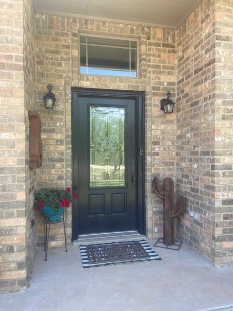 11725 Little Sorrel Trl, San Angelo, TX 76904 - view of exterior entry with brick siding