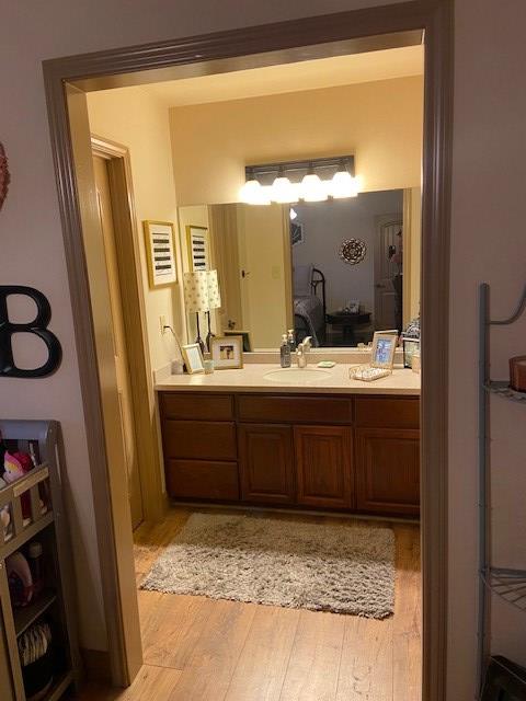 11725 Little Sorrel Trl, San Angelo, TX 76904 - ensuite bathroom with wood finished floors and vanity