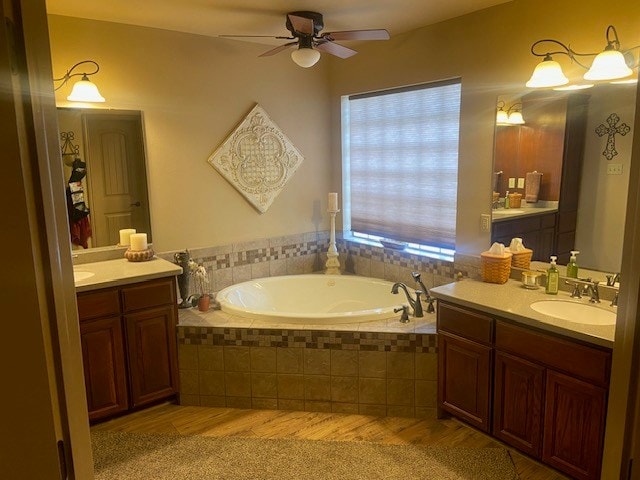11725 Little Sorrel Trl, San Angelo, TX 76904 - full bath featuring wood finished floors, ceiling fan, two vanities, and a garden tub