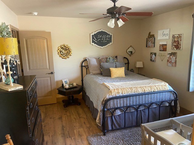 11725 Little Sorrel Trl, San Angelo, TX 76904 - bedroom with wood finished floors and ceiling fan