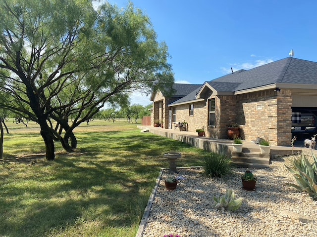 11725 Little Sorrel Trl, San Angelo, TX 76904 - view of green lawn featuring an attached garage