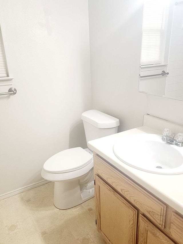 half bathroom featuring toilet and vanity