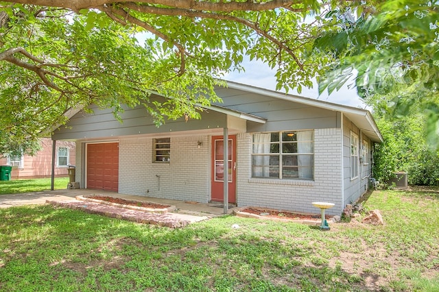 136 Arlington St, San Angelo, TX 76903 - view of front facade featuring brick siding, an attached garage, a front yard, and central air condition unit