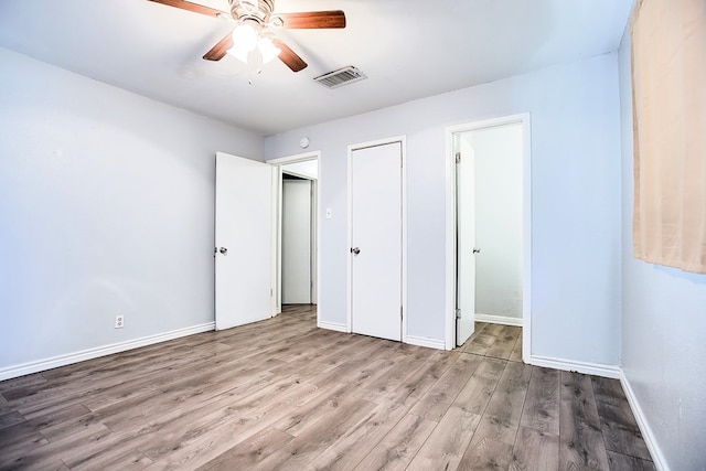 136 Arlington St, San Angelo, TX 76903 - unfurnished bedroom featuring wood finished floors, baseboards, and a ceiling fan