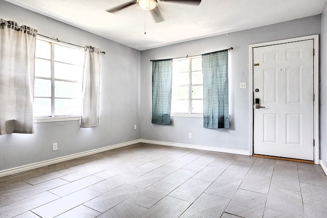 136 Arlington St, San Angelo, TX 76903 - foyer featuring ceiling fan, healthy amount of natural light, and baseboards