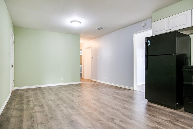 136 Arlington St, San Angelo, TX 76903 - unfurnished living room with light wood-style floors and baseboards