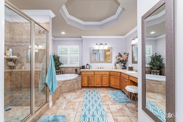 5531 Woodbine Ln, San Angelo, TX 76904 - full bathroom featuring ornamental molding, a bath, a shower stall, a raised ceiling, and double vanity