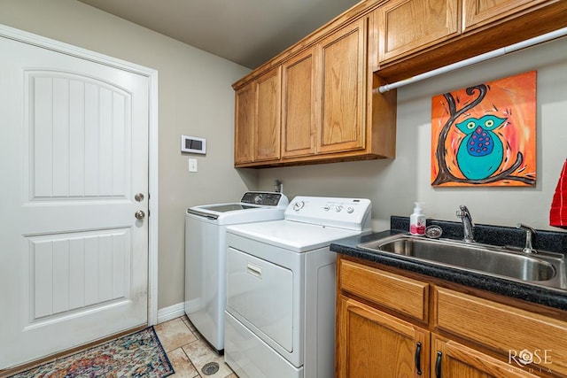 5531 Woodbine Ln, San Angelo, TX 76904 - laundry room with washer and clothes dryer, cabinet space, baseboards, and light tile patterned flooring