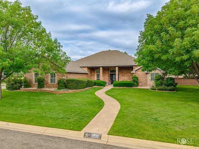 5531 Woodbine Ln, San Angelo, TX 76904 - view of front of property with a front lawn, roof with shingles, and brick siding