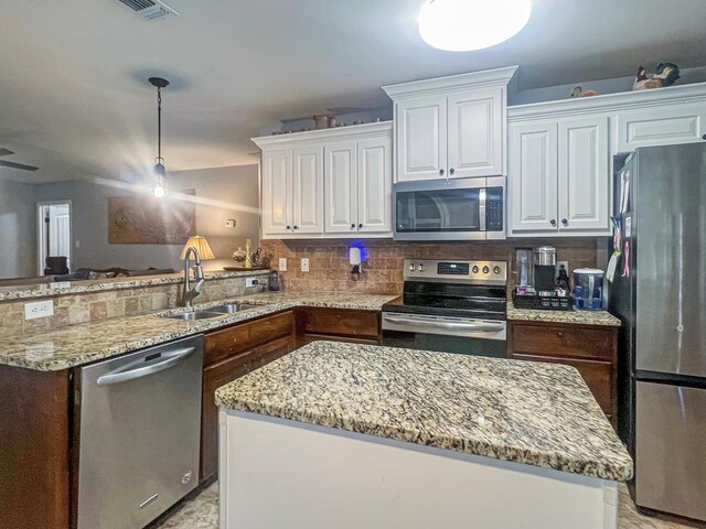 kitchen featuring white cabinetry, appliances with stainless steel finishes, sink, and tasteful backsplash