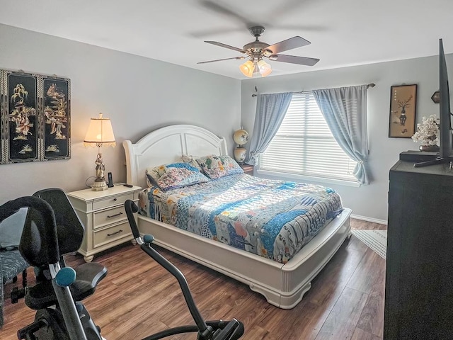 bedroom with dark wood-type flooring and ceiling fan