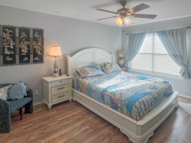 bedroom featuring ceiling fan and dark hardwood / wood-style flooring