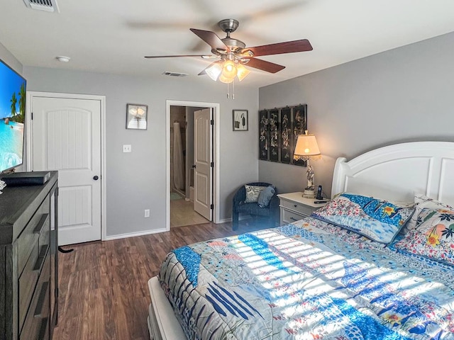 bedroom with dark hardwood / wood-style flooring, ceiling fan, and ensuite bathroom