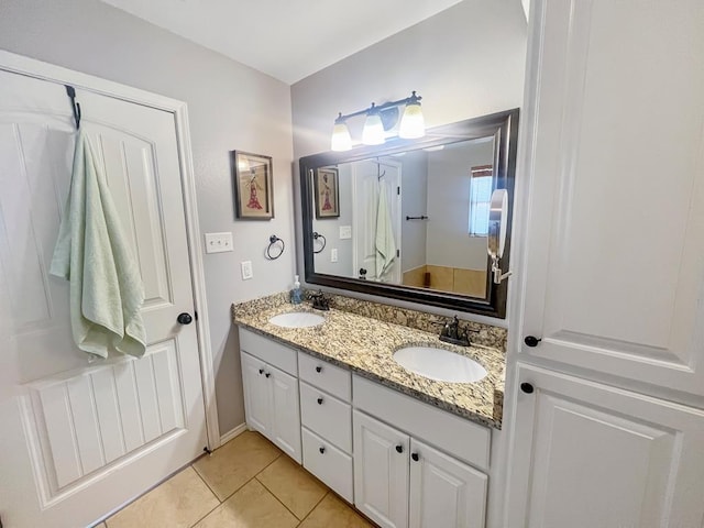 bathroom with tile patterned flooring and vanity