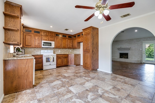 3868 Honeysuckle Ln, San Angelo, TX 76904 - kitchen featuring white appliances, a sink, open shelves, brown cabinets, and a ceiling fan