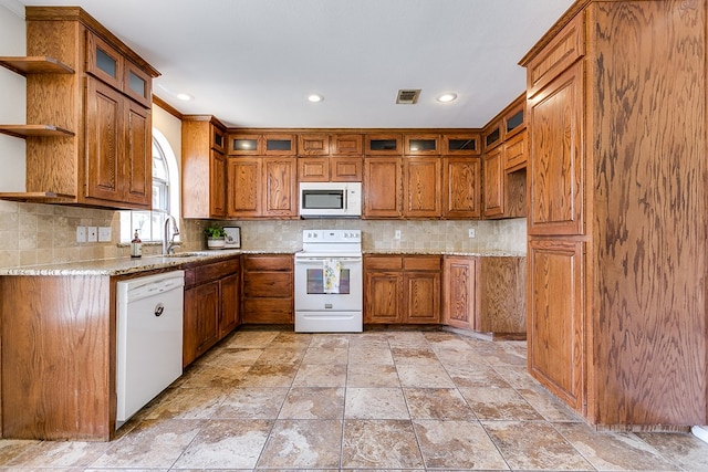 3868 Honeysuckle Ln, San Angelo, TX 76904 - kitchen with white appliances, open shelves, brown cabinets, a sink, and recessed lighting