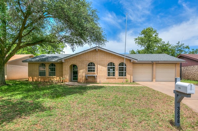 3868 Honeysuckle Ln, San Angelo, TX 76904 - ranch-style home with a garage, brick siding, driveway, and a front yard