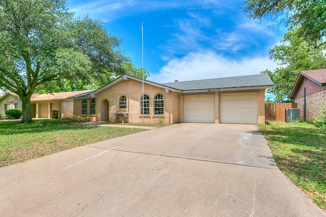 3868 Honeysuckle Ln, San Angelo, TX 76904 - view of front of house featuring brick siding, a garage, driveway, and central AC unit