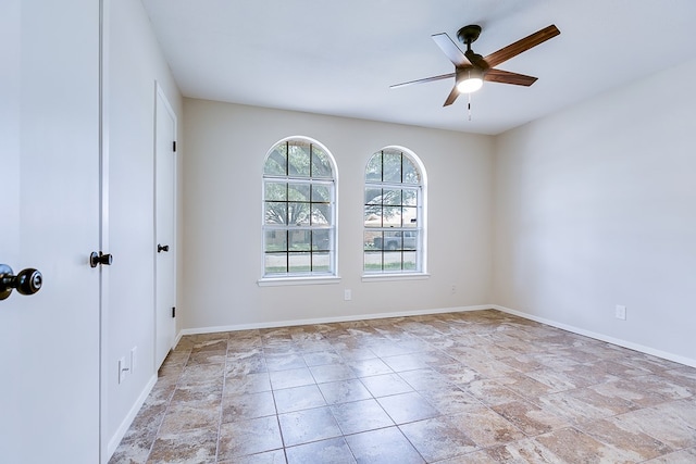3868 Honeysuckle Ln, San Angelo, TX 76904 - spare room featuring ceiling fan, stone finish flooring, and baseboards