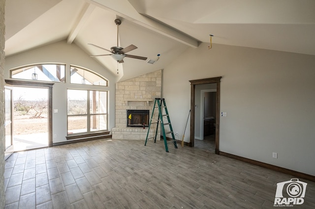 unfurnished living room featuring a ceiling fan, wood finished floors, a fireplace, high vaulted ceiling, and beam ceiling