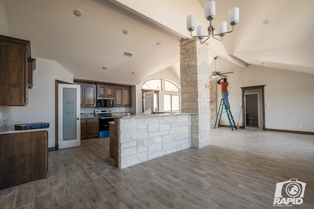 kitchen featuring stainless steel microwave, range with electric stovetop, dark wood-style floors, and ornate columns