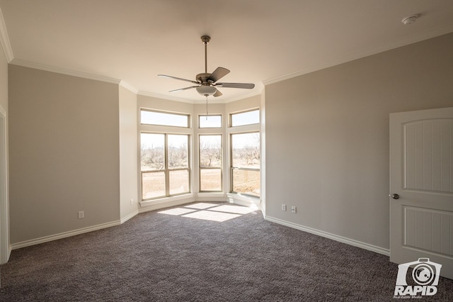 carpeted spare room featuring ornamental molding, ceiling fan, and baseboards