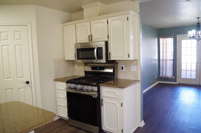 kitchen featuring dark wood finished floors, a notable chandelier, white cabinets, and stainless steel appliances