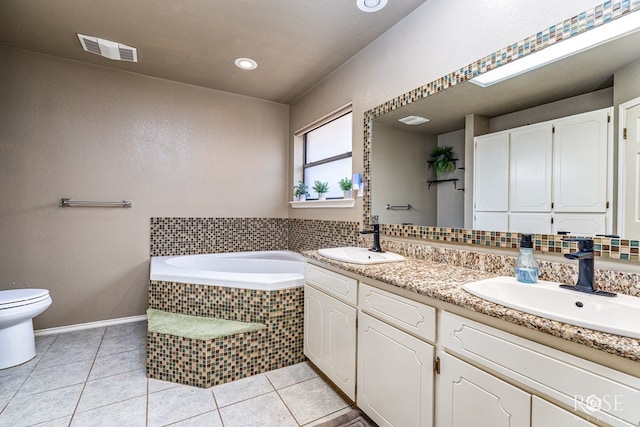 3413 Sequoia Cir, San Angelo, TX 76904 - bathroom featuring double vanity, a bath, toilet, tile patterned flooring, and recessed lighting