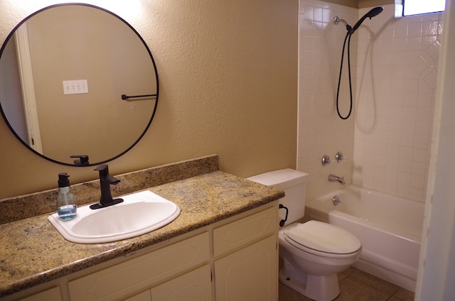 full bathroom with vanity, washtub / shower combination, tile patterned floors, toilet, and a textured wall