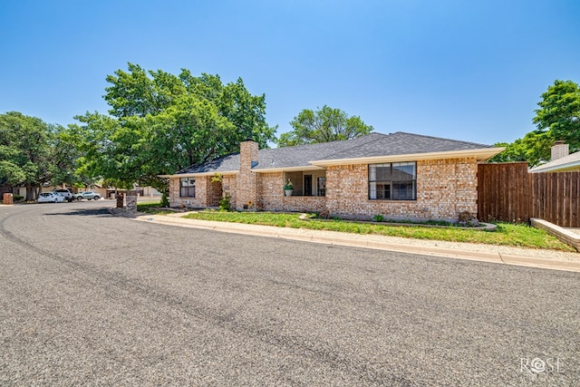 3413 Sequoia Cir, San Angelo, TX 76904 - ranch-style home with brick siding, a chimney, and a shingled roof