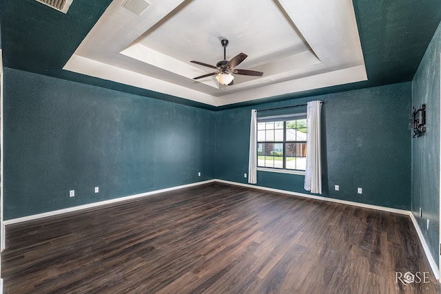 3413 Sequoia Cir, San Angelo, TX 76904 - spare room with a tray ceiling, wood finished floors, ceiling fan, baseboards, and a textured wall