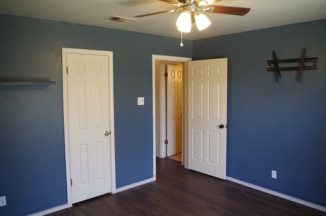 unfurnished bedroom with a ceiling fan, wood finished floors, baseboards, and visible vents