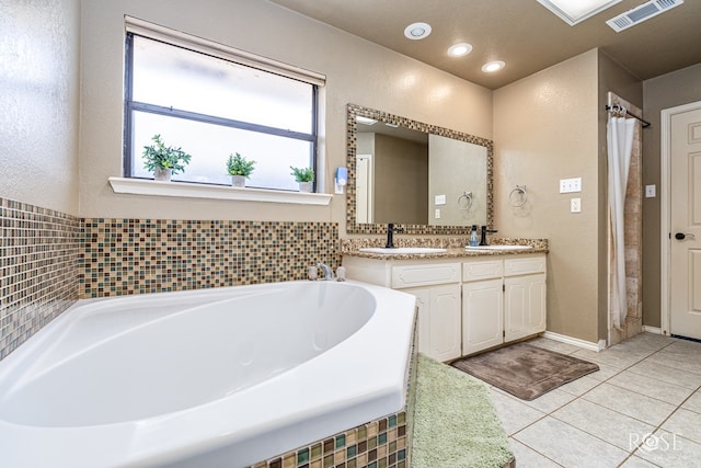3413 Sequoia Cir, San Angelo, TX 76904 - bathroom featuring double vanity, a bath, tile patterned floors, a textured wall, and recessed lighting