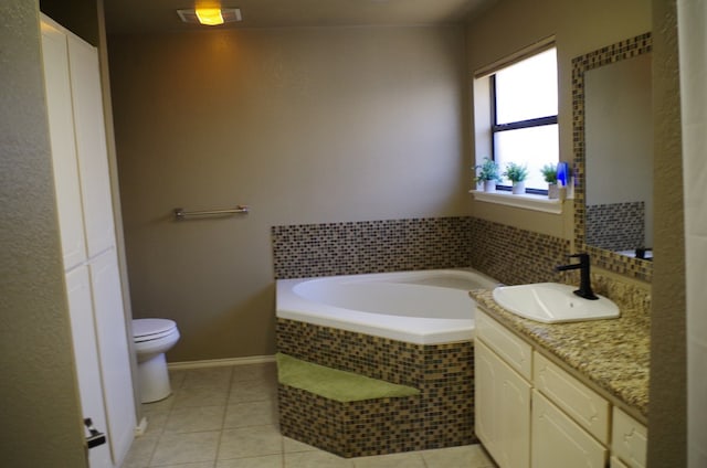 bathroom with visible vents, toilet, a garden tub, tile patterned floors, and vanity